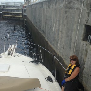 Claudia handling lines as we lock. Notice the water level change on lock wall