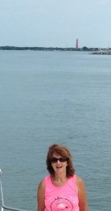 Claudia with lighthouse in background. Oops, we missed our turn trying to get this pic.